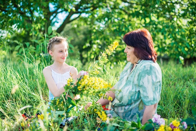 Grandmother and granddaughter with flowers