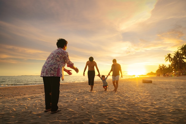 Grandmother and her family play togather on the beach