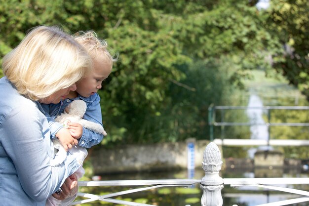 Grandmother holding baby girl outdoors