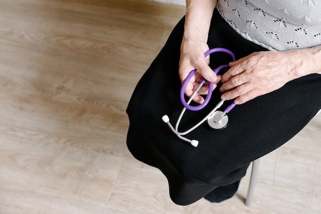 The grandmother holds a stethoscope in hand