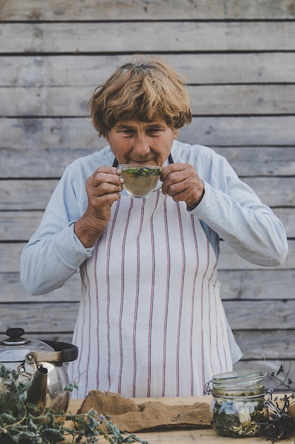 Grandmother makes tea with medicinal herbs Selective focus