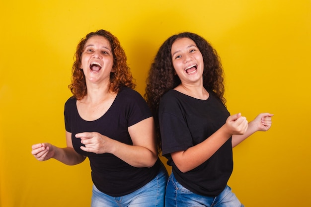 Grandmother and niece Brazilian Latin American curls afro hair curly dancing happy playing dancing family photo beautiful Mothers Day Fraternity Love