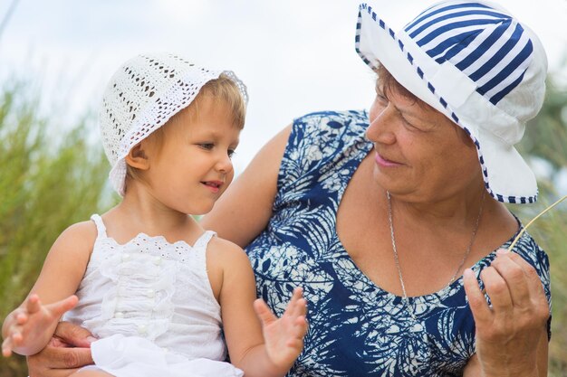 Grandmother playing with granddaughter outdoors