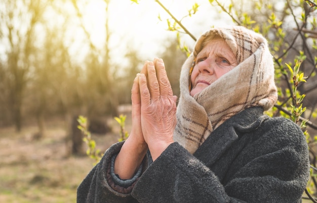 Grandmother pray for faith spirituality and religion. Asking God for good luck, success, forgiveness