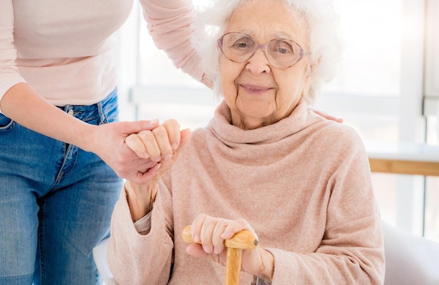 Grandmother supported by woman