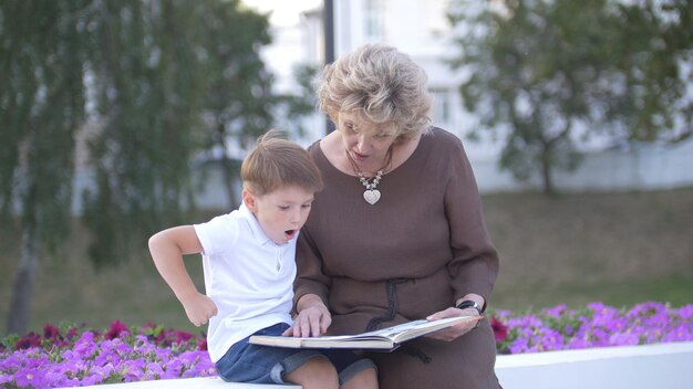 Grandmother with grandson reading a book together