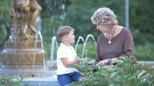 Grandmother with grandson reading a book together