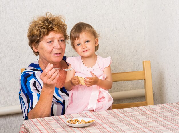 Grandmother with her granddaughter in the kitchen