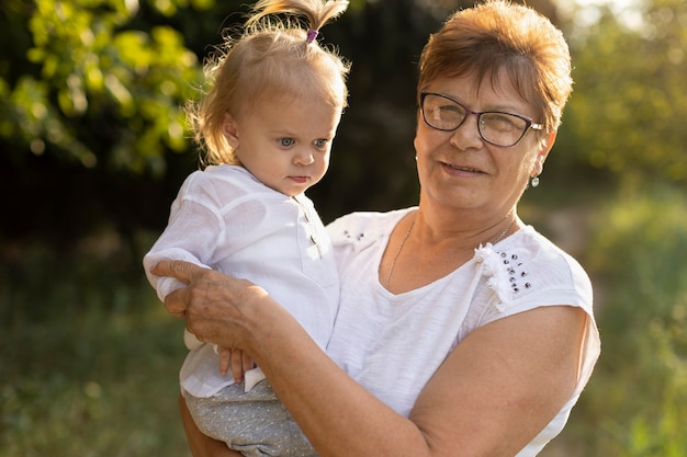 Grandmother with her granddaughter in nature