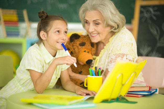 Grandmother with little girl doing homework