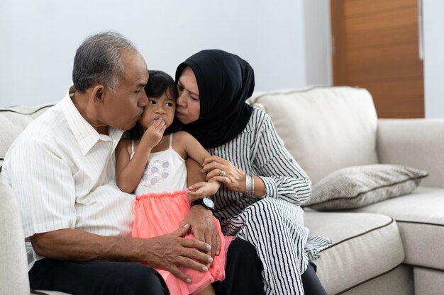 Grandparent kisses granddaughter on a chick