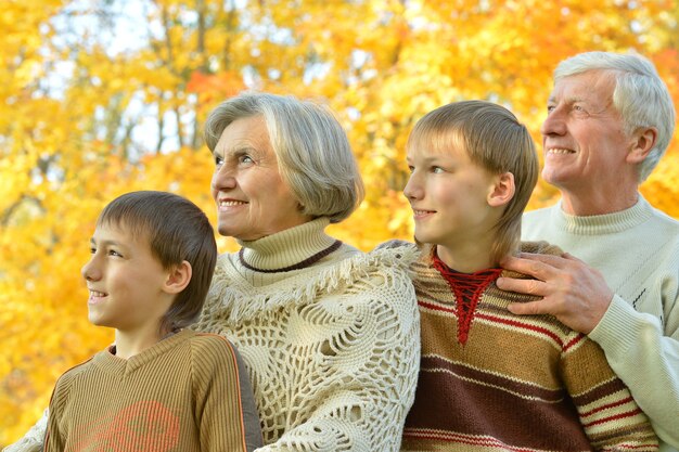 Grandparents and grandchildren together in autumn park