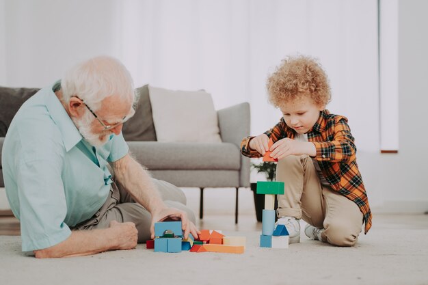 Grandparents and grandson playing at home - Family at home, grandfather taking care of nephew