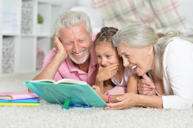 Grandparents helping granddaughter to do homework