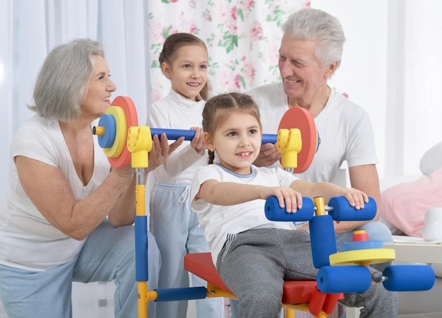 Grandparents and little granddaughters doing exercises