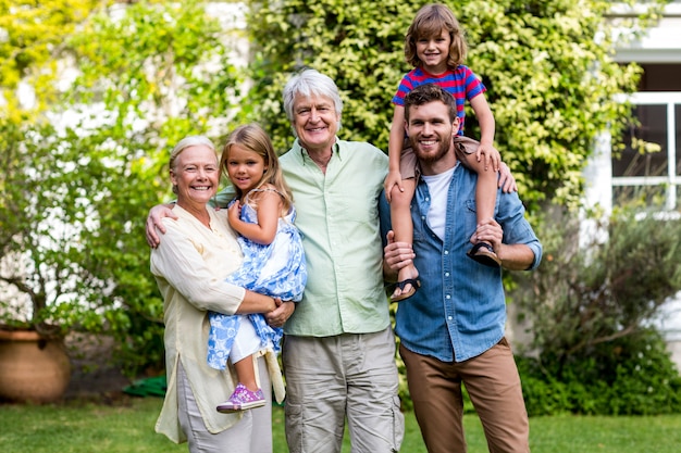 Grandparents with grandchildren and son at yard