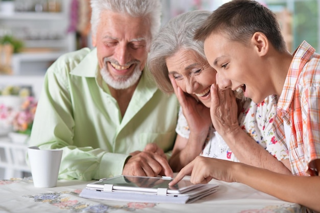 Grandparents with grandson using laptop