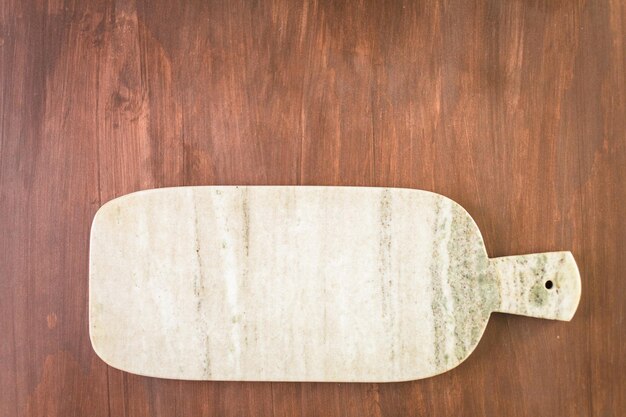 Granit cutting board on a wood background.