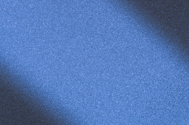 Granite background with blue color with small dots. Darkening left and right diagonally.