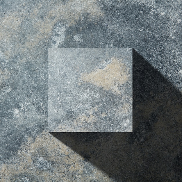 Granite cube with shadow isolated on dark stone background, flat lay