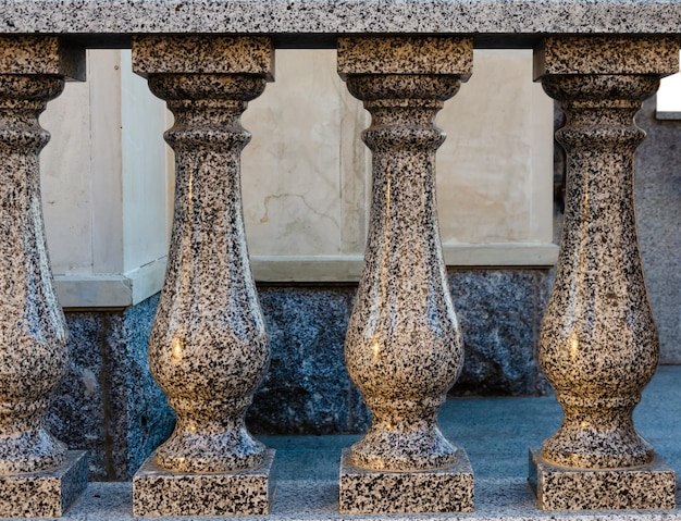 Granite fence with curly legs.