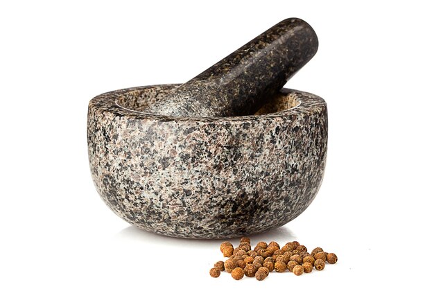 granite mortar ans spices isolated on white background
