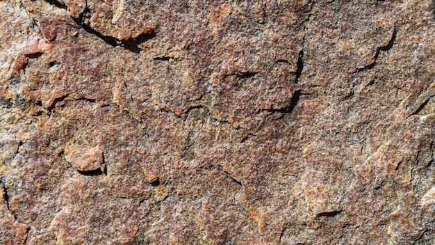 Granite stone texture. Cracked granite rock surface. Natural stone backdrop. Close-up