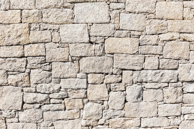 Photo granite stone wall background texture. dry masonry wall