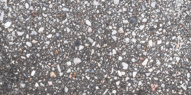 Granito texture grigio naturale motivo di piastrelle pavimento per il design superficie granulosa della pavimentazione sfondo astratto pietre scure vecchio muro urbano stagionato modello con spazio vuoto