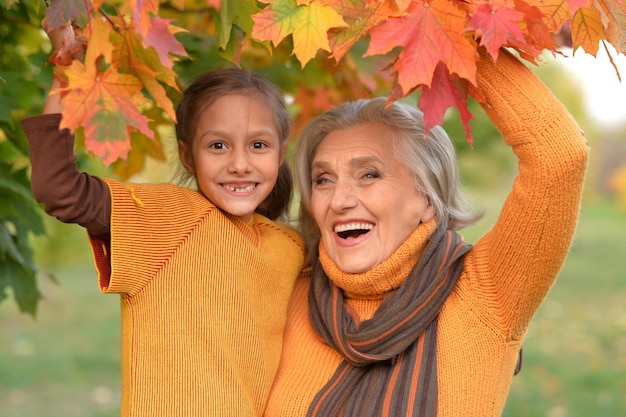 Granny and granddaughter posing outdoors in autumn part