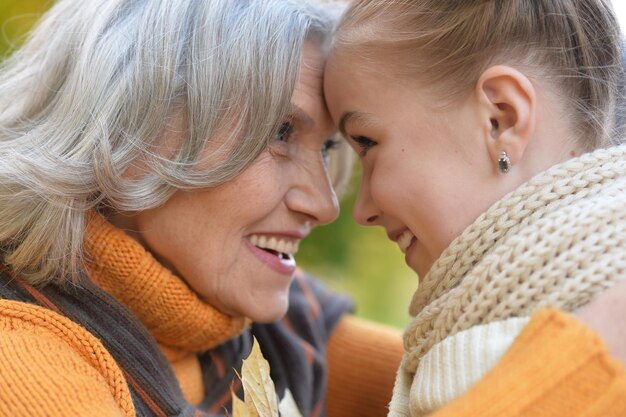 Granny and granddaughter posing outdoors in autumn part