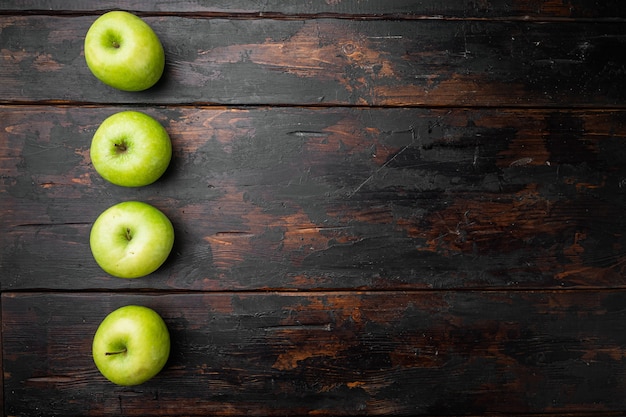 Granny smith apple set, on old dark rustic table background, top view flat lay, with copy space for text