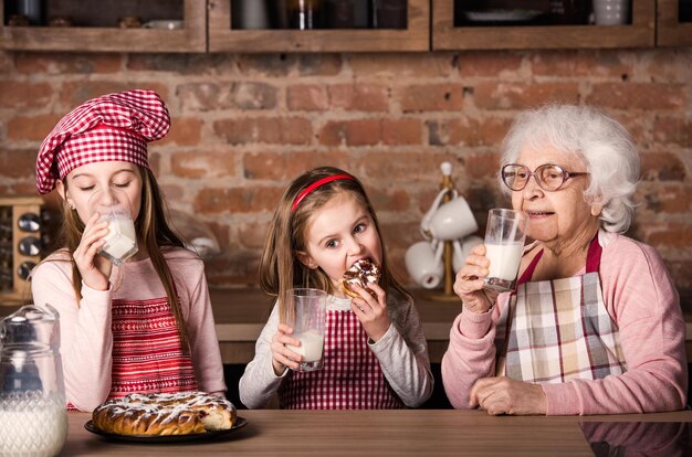 Granny with granddaughters tastying pie