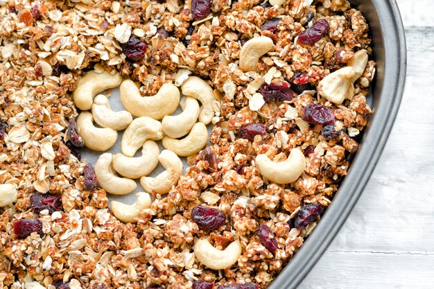 Granola in a baking dish, cashew in the shape of heart. Food . Close-up