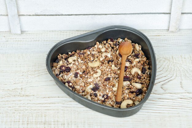 Granola on a baking heart shaped sheet