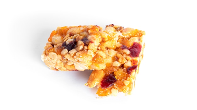 Granola bar with nuts and dried fruits isolated on a white background. High quality photo