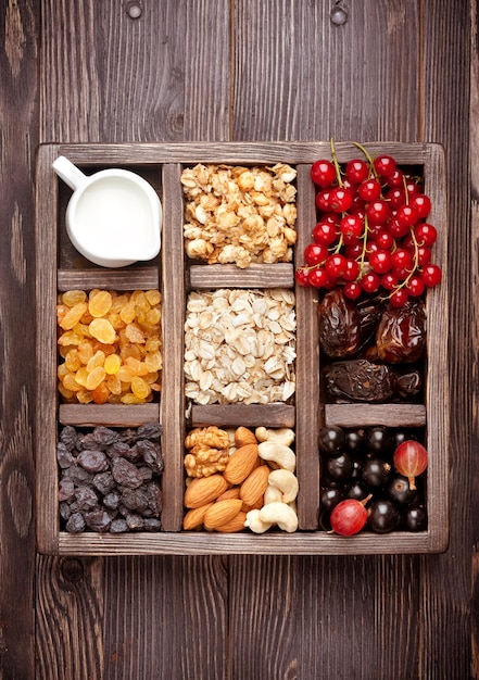 グラノーラベリーナッツドライフルーツとミルク木箱の健康食品上面図