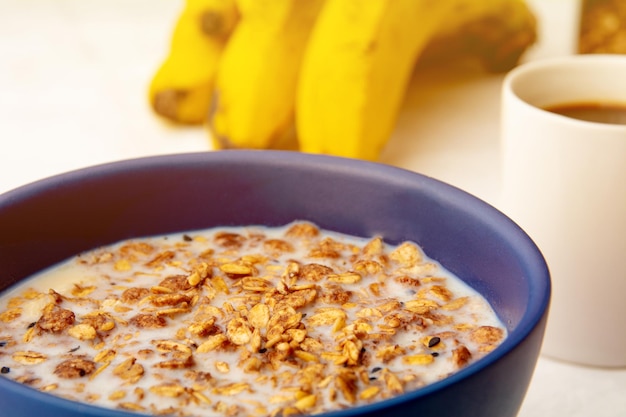 Cereali muesli con latte colazione sana caffè e banane su sfondo bianco