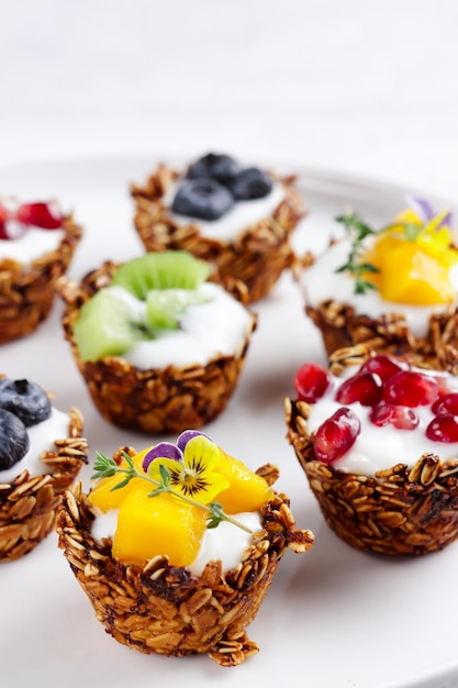 Granola cups filled with yoghurt and fruits