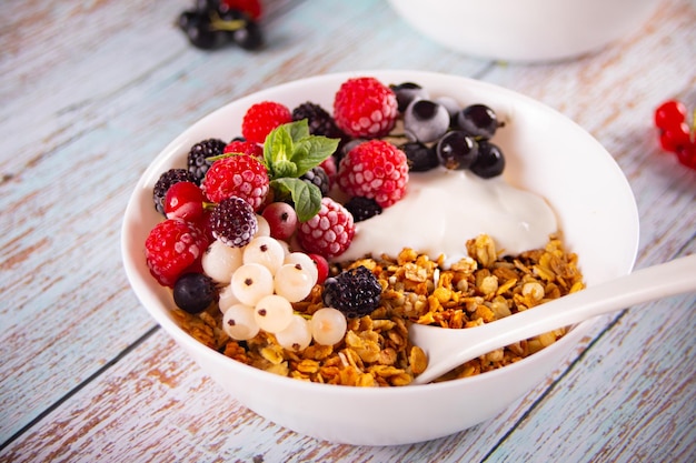 Granola muesli cereals with yogurt or milk and fresh berries Healthy breakfast concept