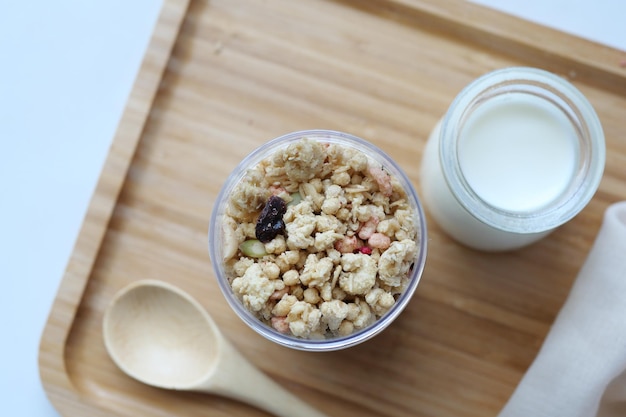 Granola Musli and glass of milk on table