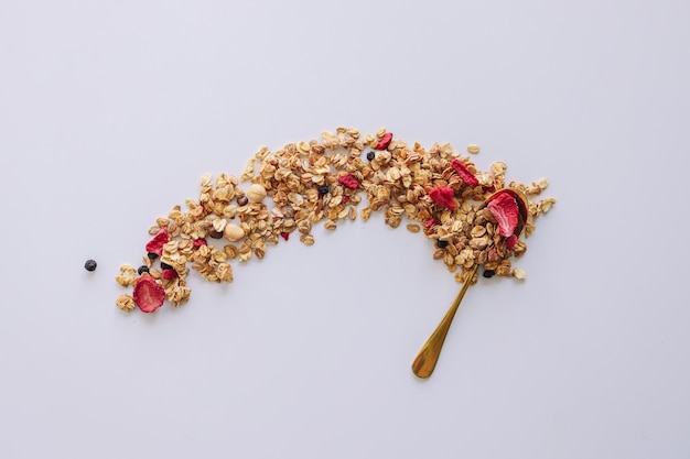 Granola on spoon isolated on white background copy space Healthy snack or breakfast concept homemade granola