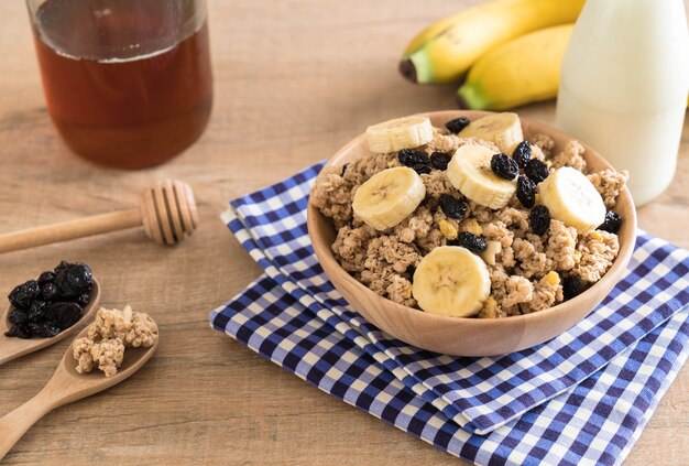 granola with banana, raisin and milk 