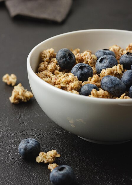 Granola with berries in white bowl