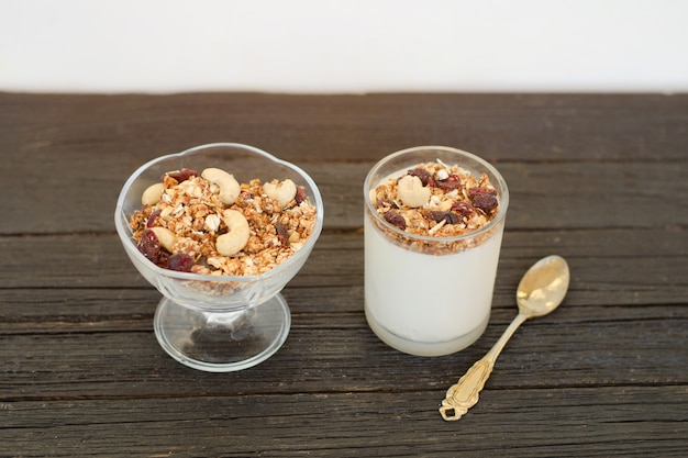 Granola with berries and yogurt on wooden table. Traditional American Breakfast