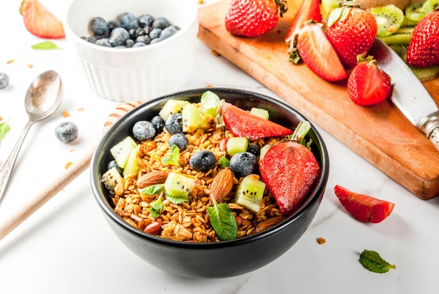 Granola with nuts, fresh berries and fruits