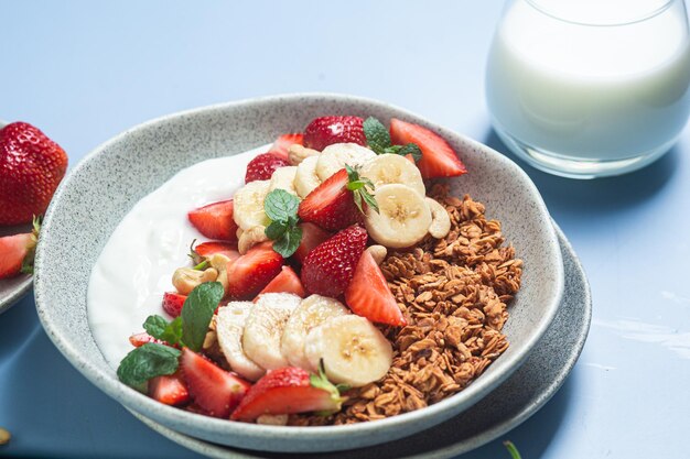 Granola with yogurt strawberry and banana in a bowl