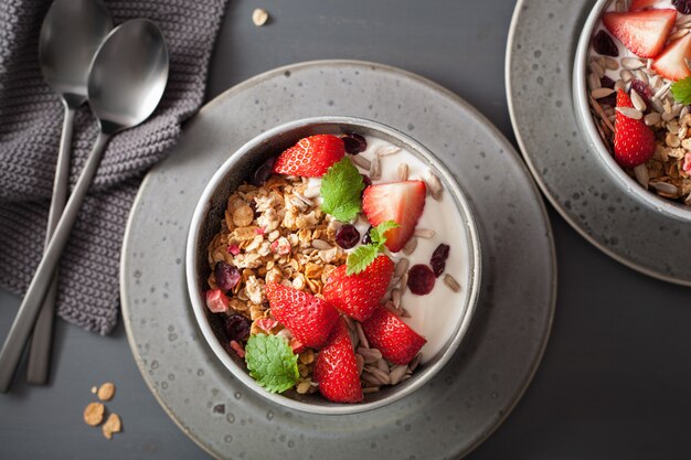 Granola and yogurt with seeds and strawberry for breakfast