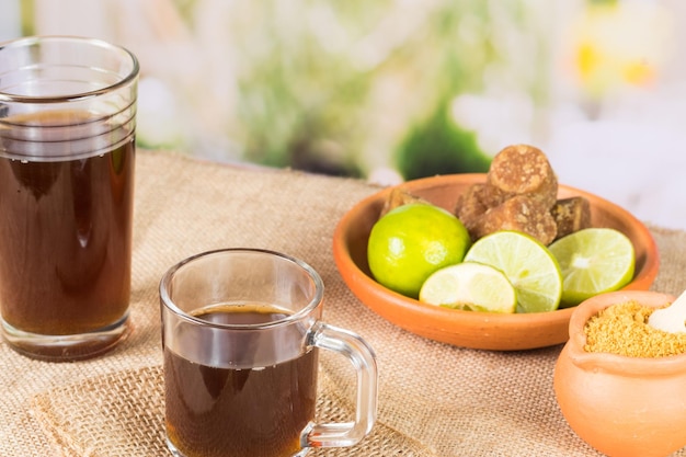 Granulated panela agua de panela and lemon or sugar cane sweets and lemon in the kitchen typical food of Colombia