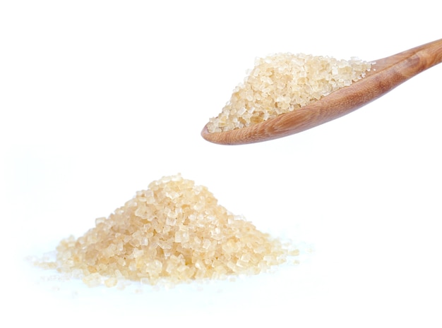 Granulated sugar in spoon isolated on white background